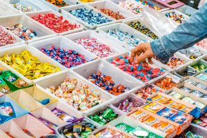 Pick 'n' Mix candy bar with a selection of wrapped candy and gum in white buckets